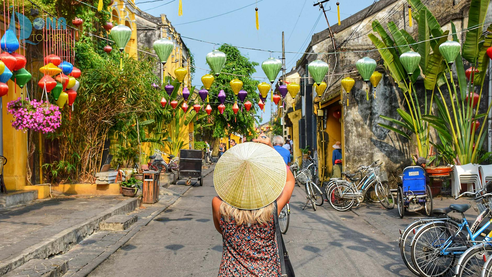 woman wearing straw hat in the middle of road