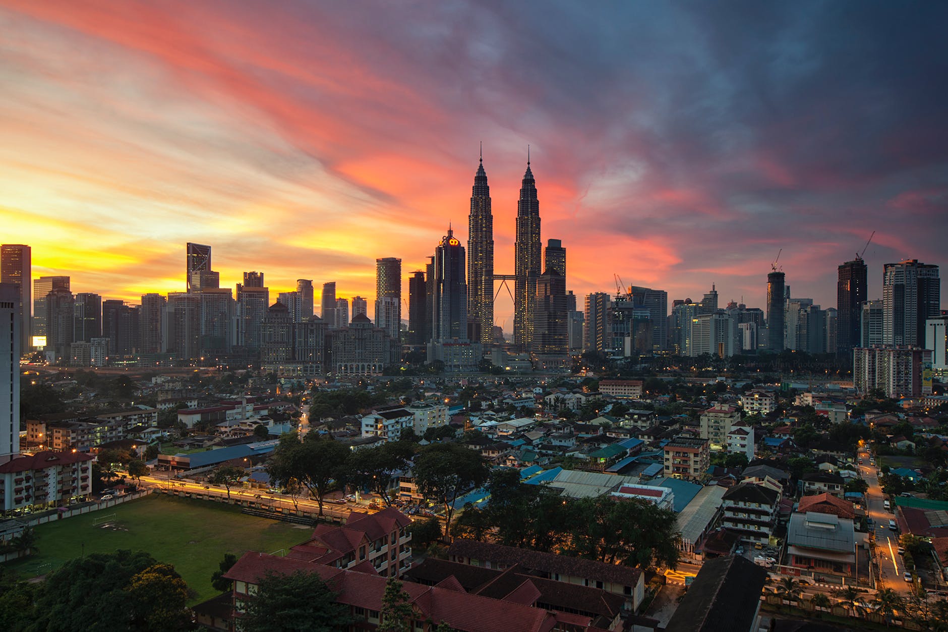 city buildings under orange sunset